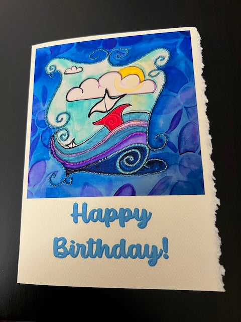Handmade birthday card on deckle‑edge art paper featuring a photographic print of an acrylic and bead‑embroidery painting titled Our Visit to the Water’s Edge, with ‘Happy Birthday’ printed on the front.