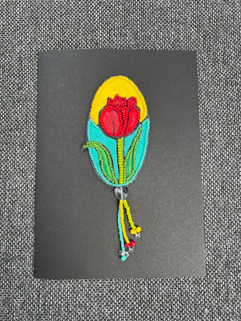 Handmade 5×7 tulip folk art card by artist Kathy Poitras, featuring acrylic painting, bead embroidery, mixed‑media floral design, and a decorative beaded tassel.