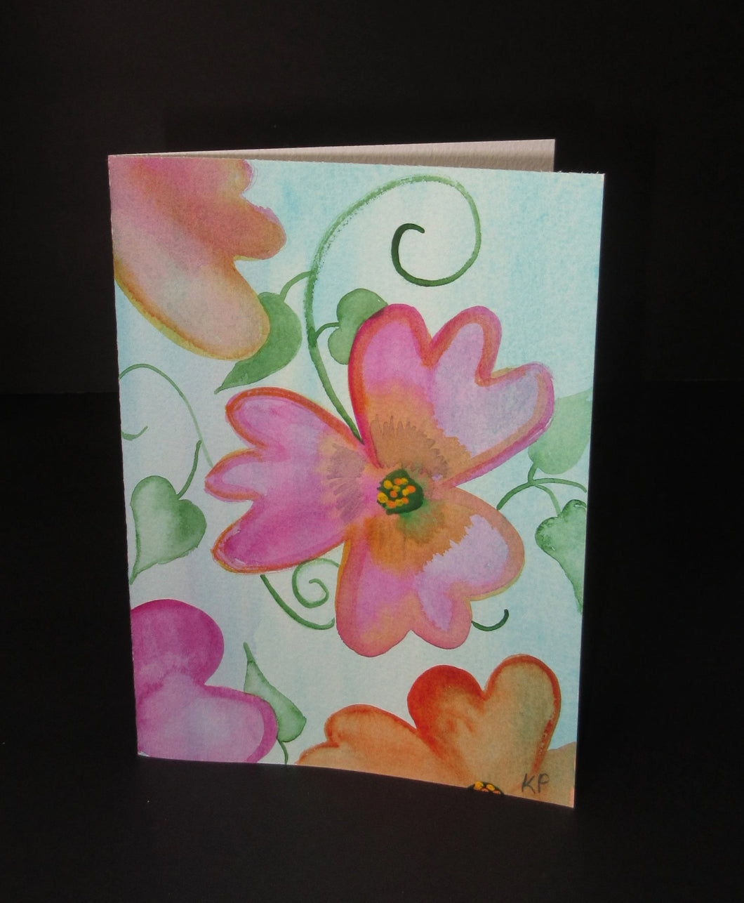 Pink floating flowers on a blue green background.  one of a kind watercolor art card